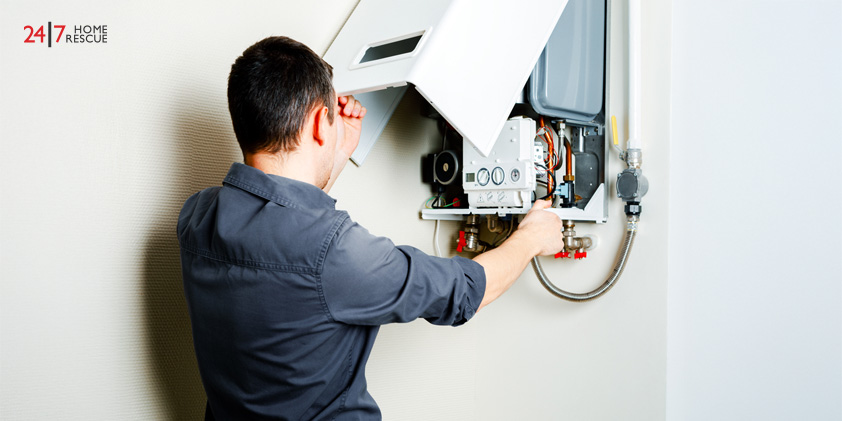 How to Prepare Your Boiler for Winter Engineer repairing boiler system at home