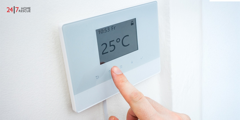 How to Prepare Your Boiler for Winter Hand adjusting central heating thermostat for room temperature control