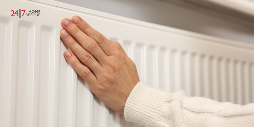 Why Is My Radiator Cold? – Common Faults and How to Fix Them Woman warming hand near heating radiator at home