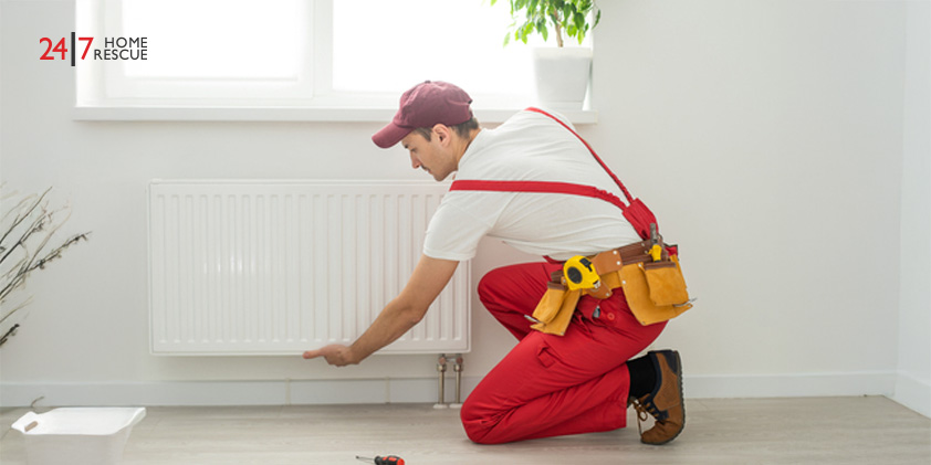 Why Is My Radiator Cold? – Common Faults and How to Fix Them Technician repairing a heating radiator with a wrench