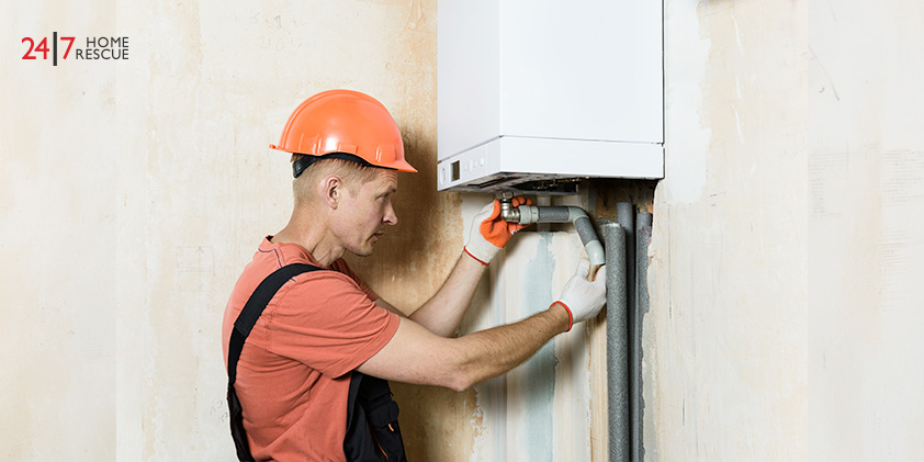 Engineer checking wall-mounted boiler