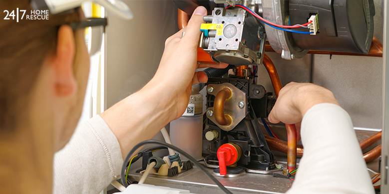 Engineer repairing gas boiler components
