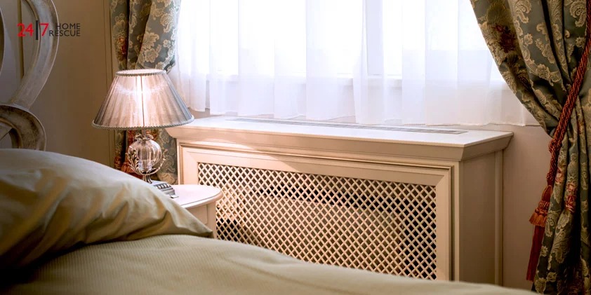 Do Radiator Covers Block Heat? Are They Worth It or Not? A Bed With a Lamp on The Side With a Radiator Cover