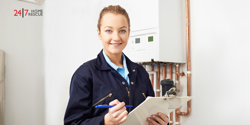 How Much Does a Boiler Service Cost in 2026? Female engineer documenting maintenance notes during boiler service inspection