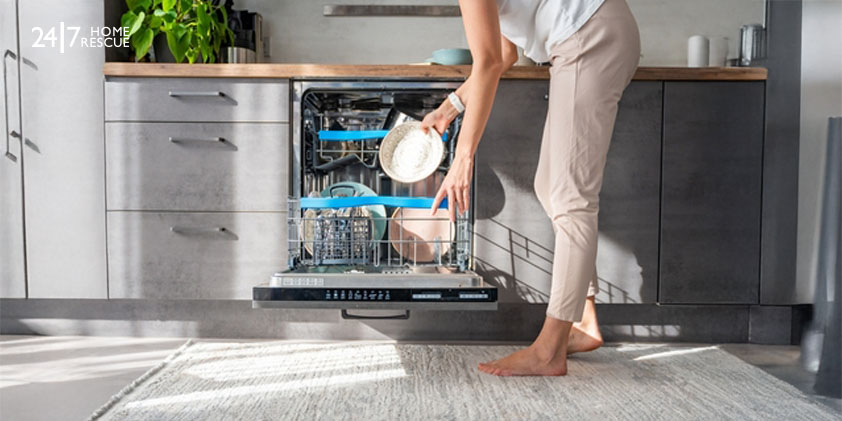 My dishwasher is not draining! Woman removes clean ceramic dishes from dishwasher