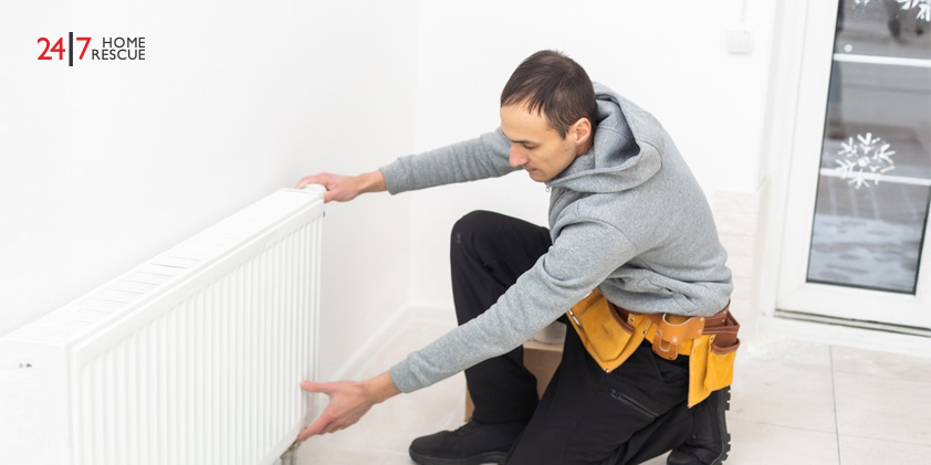 Boiler Switch On – Get Ready for the Winter Season A heating engineer adjusting a radiator to ensure the home’s heating system is working efficiently