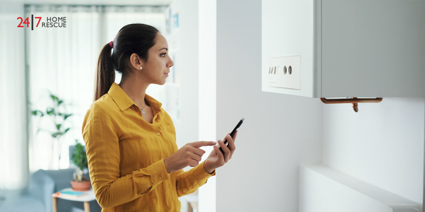 Boiler Switch On – Get Ready for the Winter Season Woman managing and programming her smart boiler using her smartphone