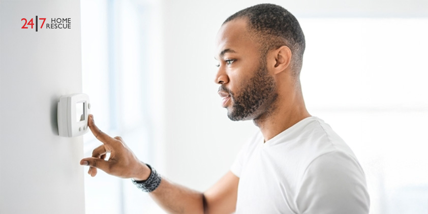 Hive vs Nest Thermostat: Best Smart Choice 2026 Man adjusting temperature on a smart home thermostat