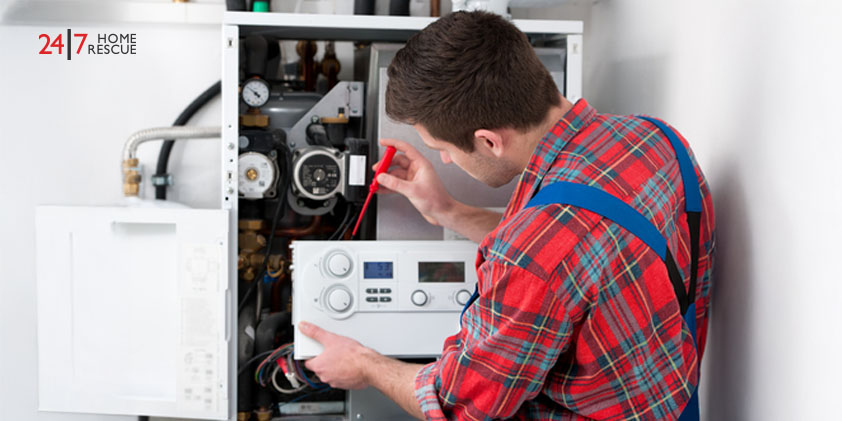 Boiler Lockout and Ignition Lockout Causes & How To Fix It Technician servicing a gas boiler for home heating and hot water