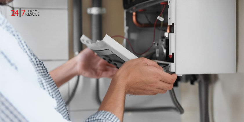 Boiler Lockout and Ignition Lockout Causes & How To Fix It Man opening the top of a gas boiler indoors during inspection