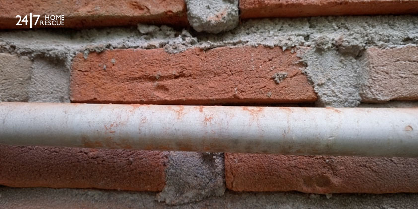 Understanding the Worcester Boiler Blue Light Flashing: Causes and Solutions brick wall background with pipes hanging on the wall