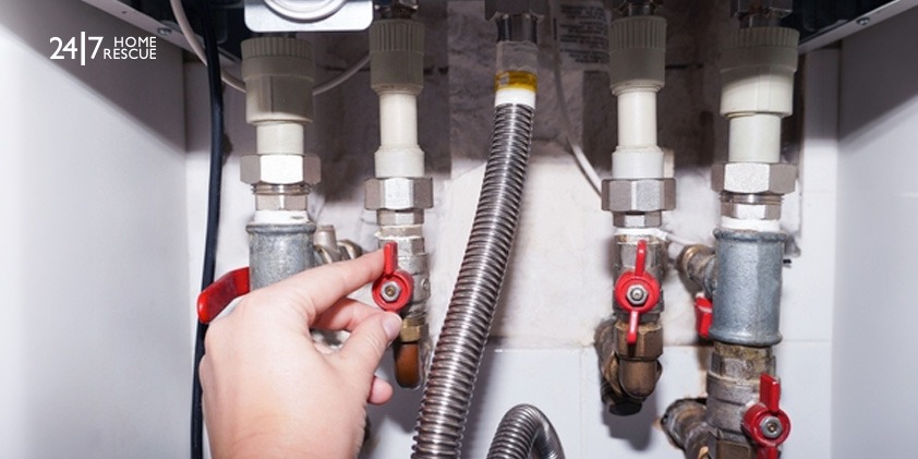 Common Reasons Behind a Vokera Boiler Red Light Warning A man checking the gas connection of a modern gas boiler