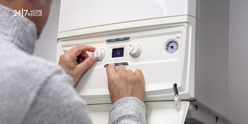 Worcester E9 Fault Code: Overheating and Systems Issues Explained A person adjusting the thermostat on their central heating system
