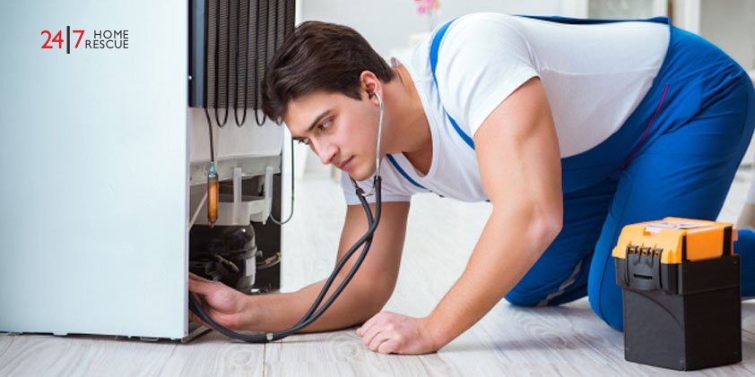 Common Fridge Freezer Faults and How To Get Them Fixed A repairman checking a fridge freezer for unusual noises