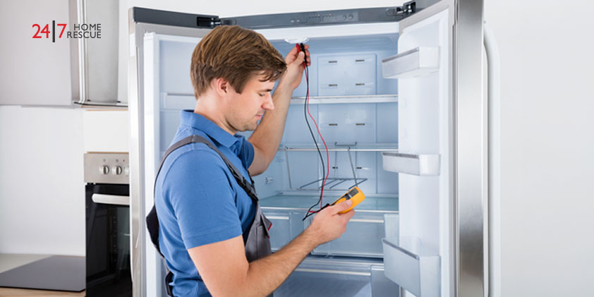 Common Fridge Freezer Faults and How To Get Them Fixed A repairman inspecting a fridge freezer