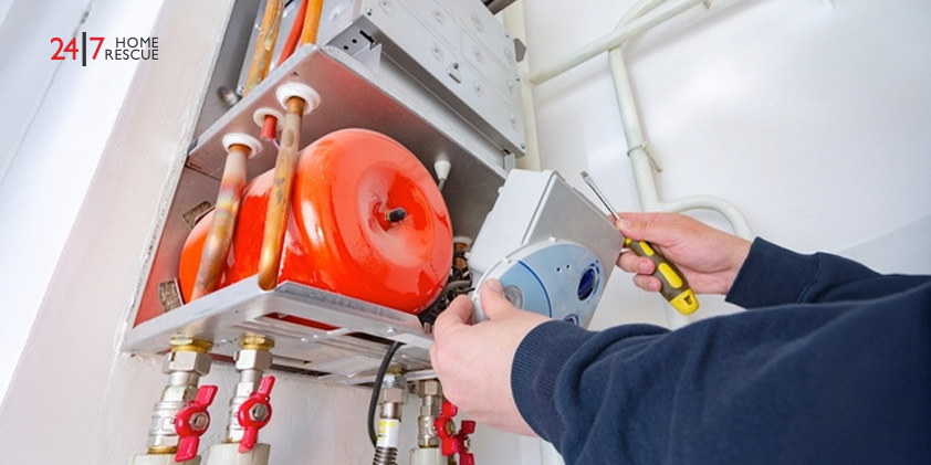 How Often Should a Boiler Be Serviced Close-up of a heating engineer repairing and inspecting the internal components of a domestic boiler