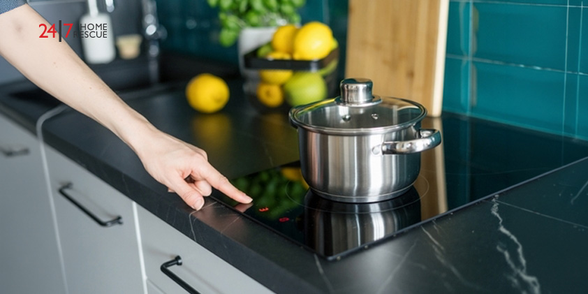 How to Unlock an Induction Hob - Complete UK Guide A person pressing the touch controls on an induction hob next to a saucepan