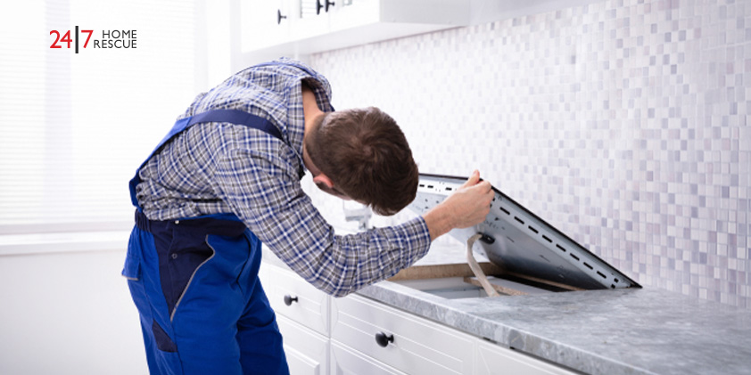 How to Unlock an Induction Hob - Complete UK Guide Engineer repairing an induction hob after lock or control panel issues in a modern kitchen