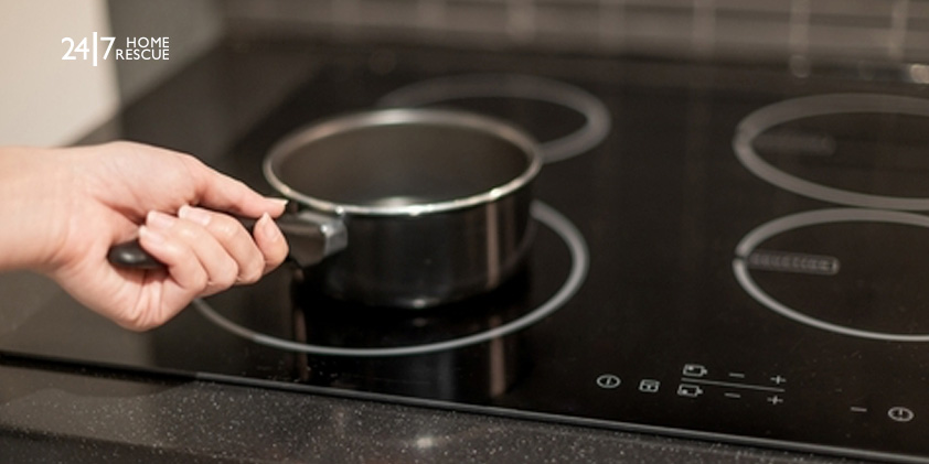 How to Unlock an Induction Hob - Complete UK Guide Hand placing a pan on an induction hob after unlocking the cooktop controls