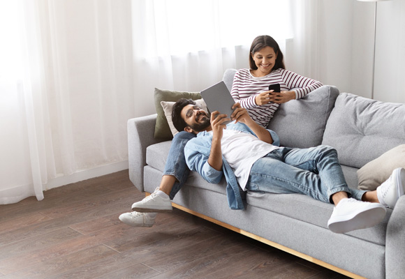 Couple relaxing at home on a sofa with reliable boiler repair service