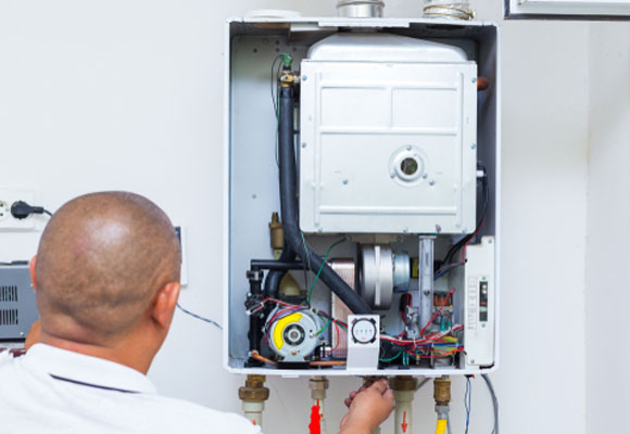 Engineer inspecting the open internal components of a boiler