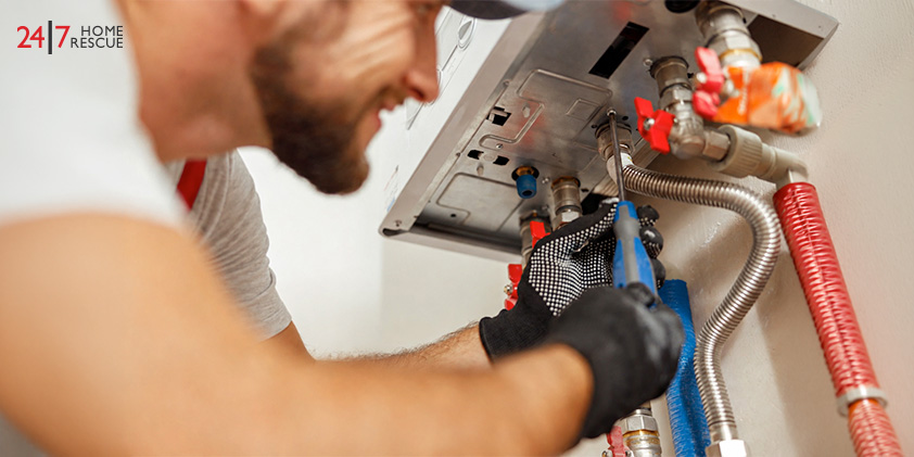 Engineer fixing combi boiler