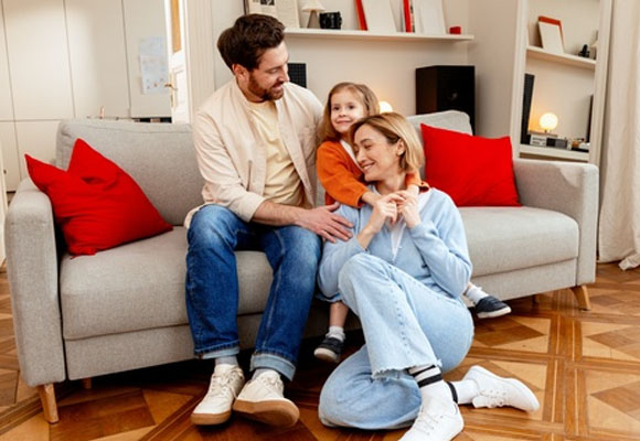 Family relaxing together at home on a sofa having trusted Gas Safe boiler repair