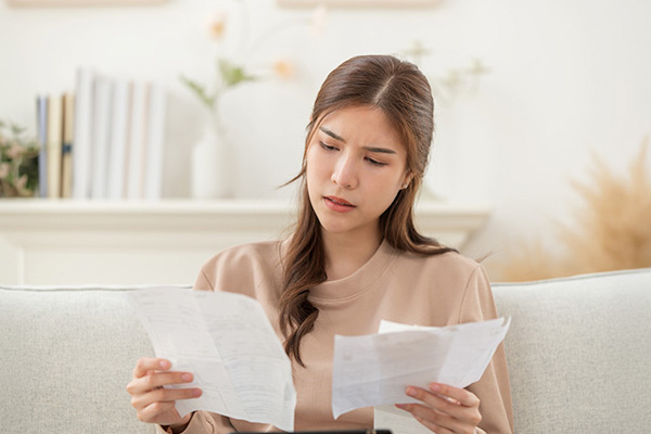 Woman reviewing boiler cover bills
