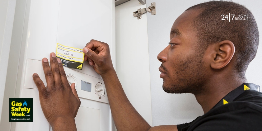 Engineer applying annual boiler service sticker