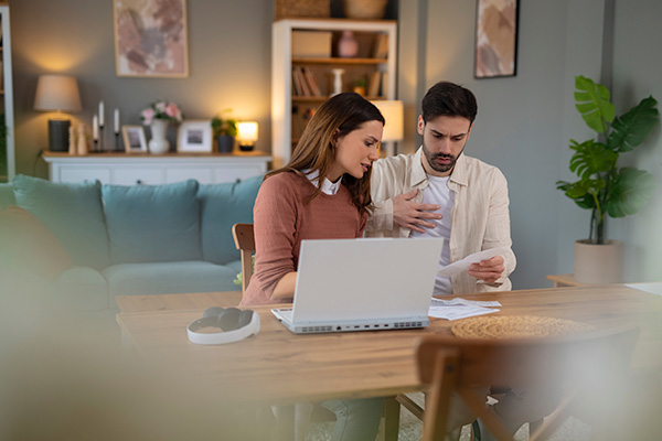 Couple looking at bills at home