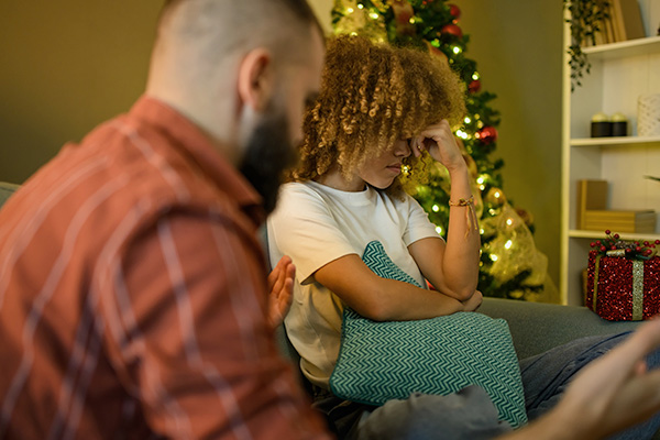 Couple stressed sitting together on sofa