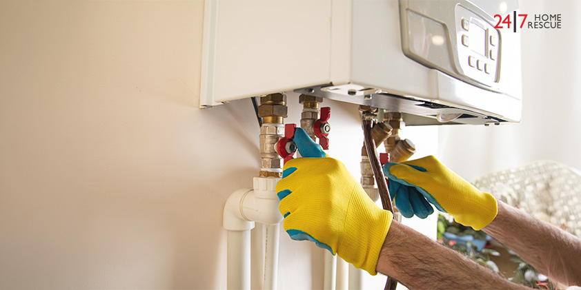Engineer servicing combi boiler