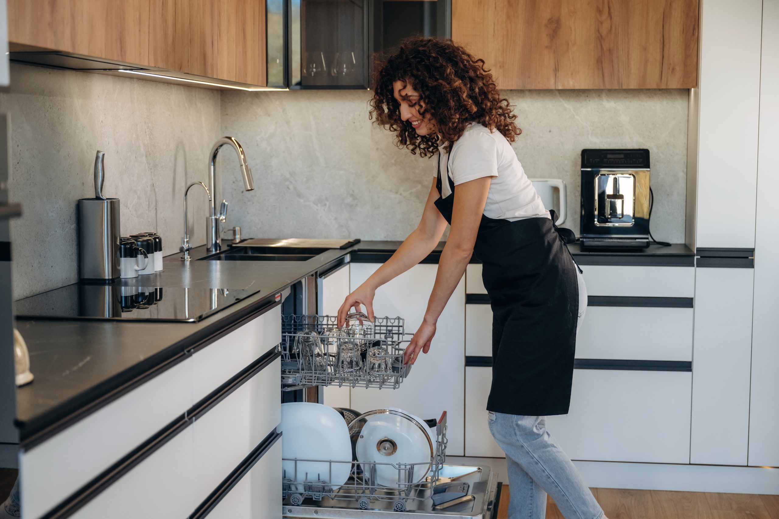 Woman loading dishes in dishwasher